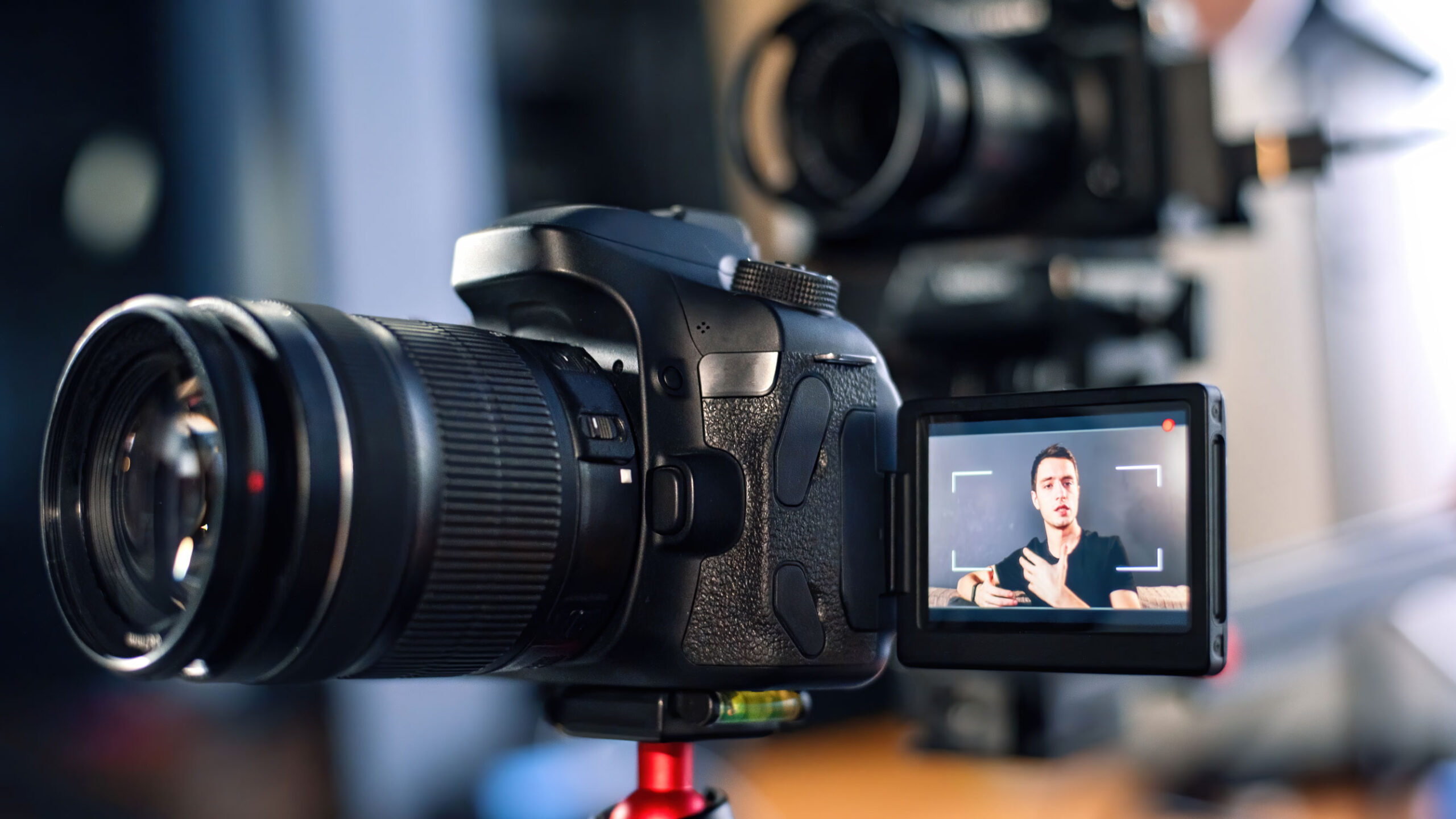 man talking camera recording himself vlog working from home young content creator multiple cameras scaled