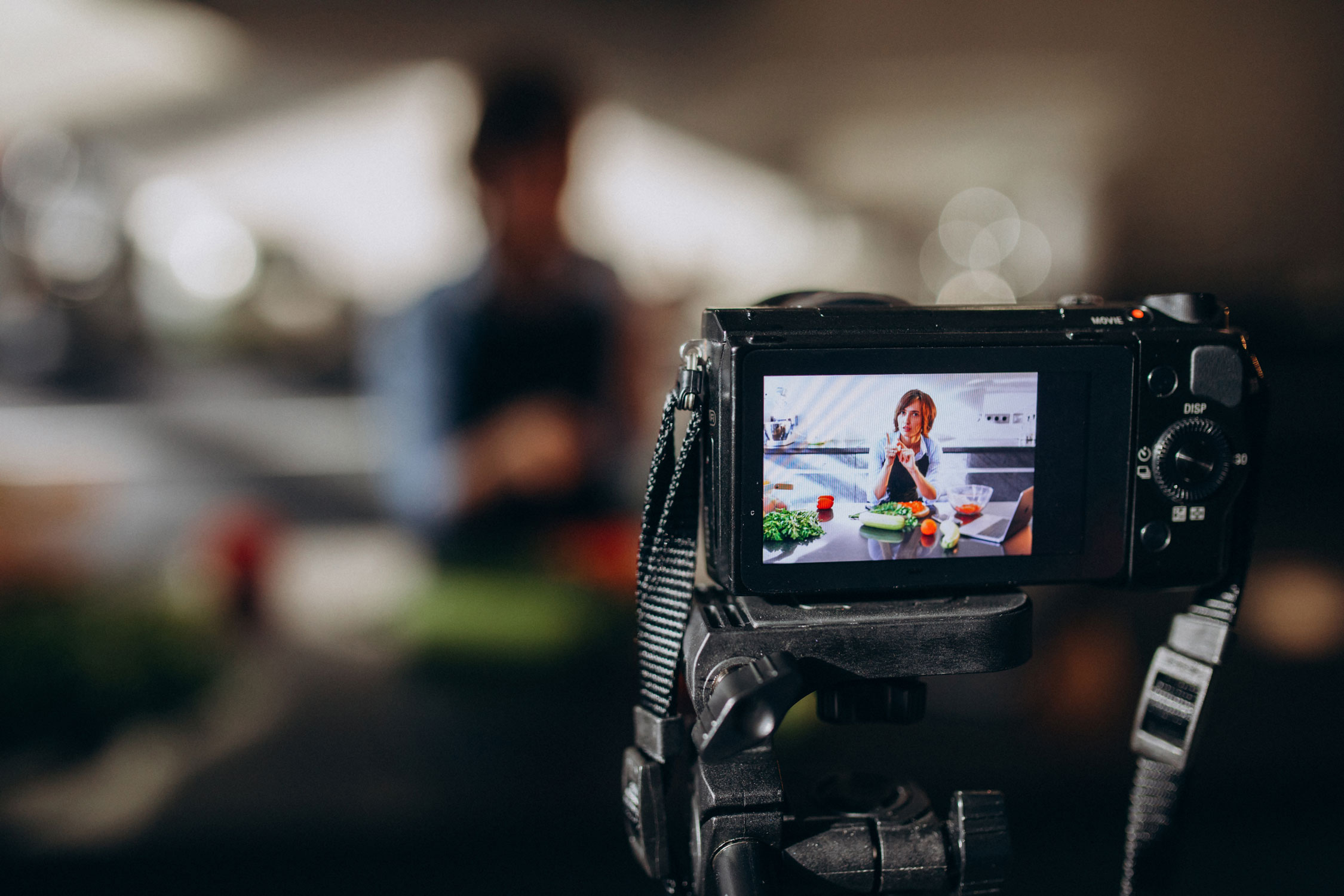young woman videoblogger cooking kitchen filming